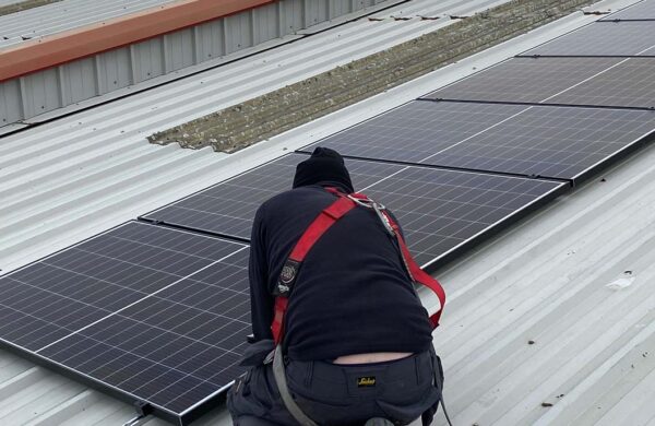 Island renewables employee fitting solar PV on seacat services roof