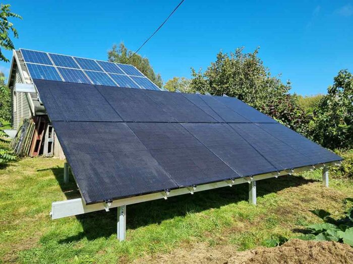 Solar panels fitted to a ground panel rack in a garden by island renewables