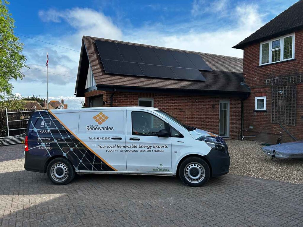 Island Renewables van parked in front of a solar installation on a property roof isle of wight