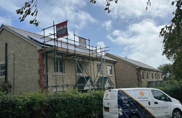 Solar panels being fitted to a house in brighstone isle of wight with a island renewables van parked outside