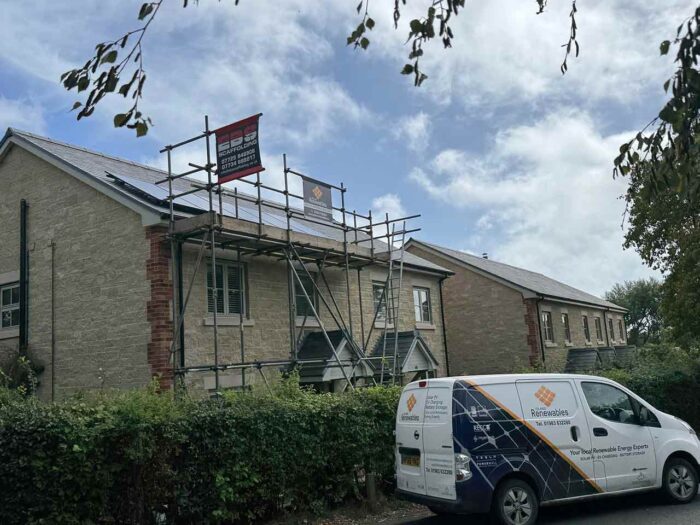 Solar panels being fitted to a house in brighstone isle of wight with a island renewables van parked outside